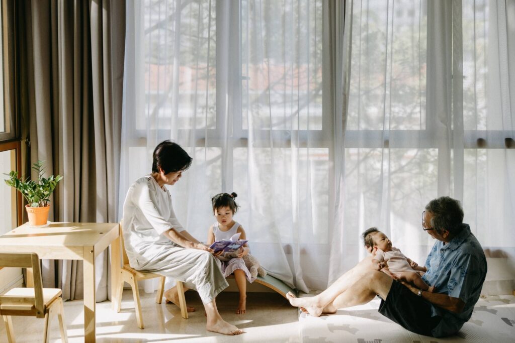 Lifestyle baby photos in Sydney of parents interacting with their baby near a window at home