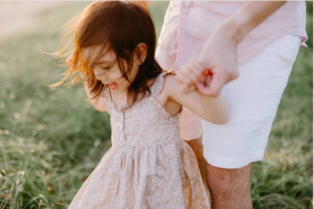 Family walking together through a Sydney park during a natural family photography session