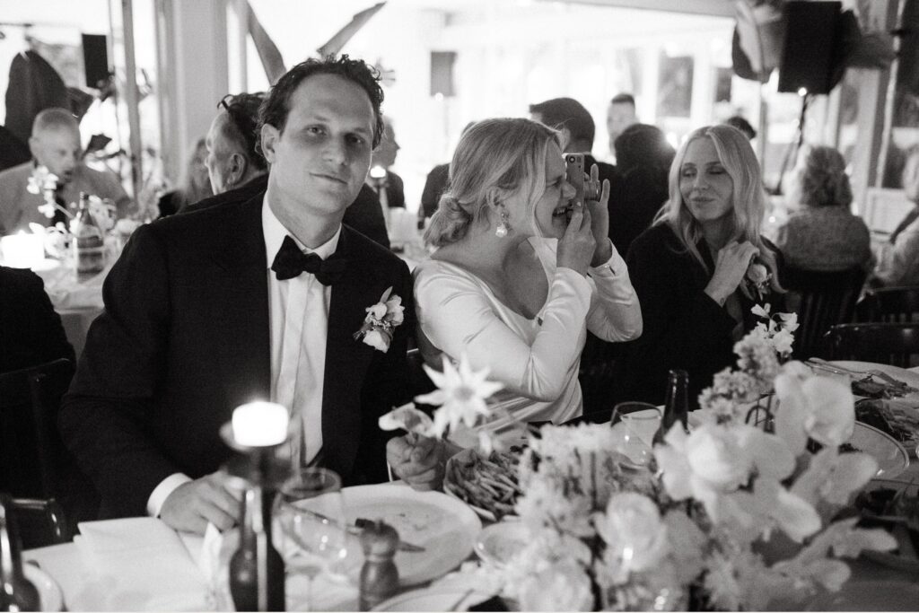Black and white candid moment capturing raw emotion between guests during wedding speeches — documentary wedding photography Sydney by Tealily Photography