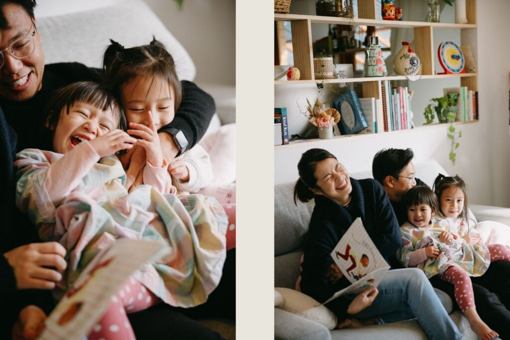 A family of four relaxed at home, giggling with a book, and being tickled by their dad