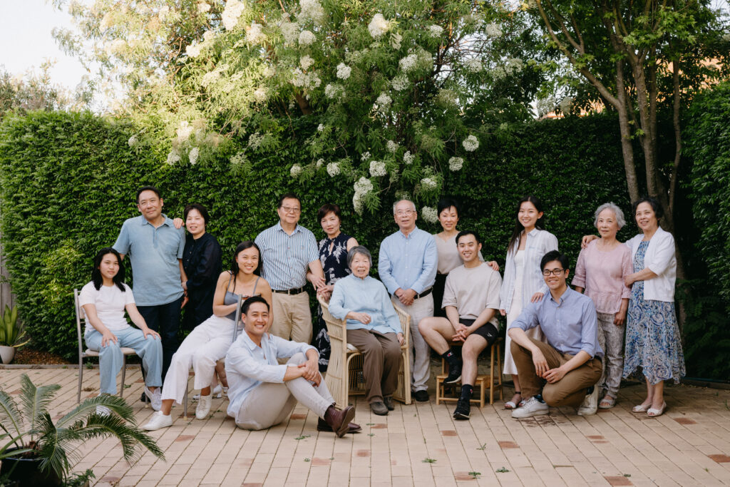 A relaxed formal portrait of three generations in grandma's courtyard