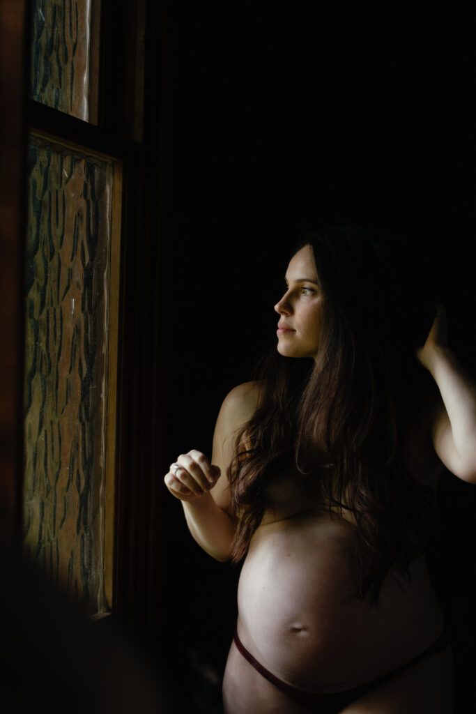 Two side by side photos of a mother at 36 weeks with her toddler at home with the bathroom light glowing on her expectant belly