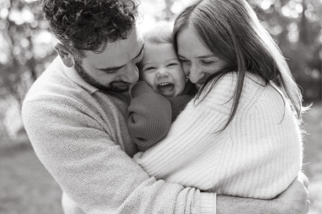 a cute family cuddle in winter knits